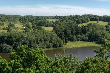 Fototapeta premium Rural Lake Valley with Forest, Meadows and Farmland for Nature Tourism and Land Management
