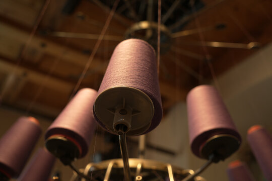 Close-up view of the spindles of a historic textile machine
