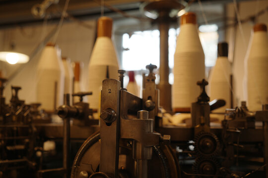 spindles and a detail of a machine in a historic weaving mill