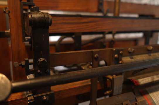 Detail of an old wooden loom with screws and mechanical details