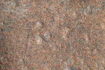 Fototapeta premium Stone texture. Detailed texture of natural pink granite stone surface close up.