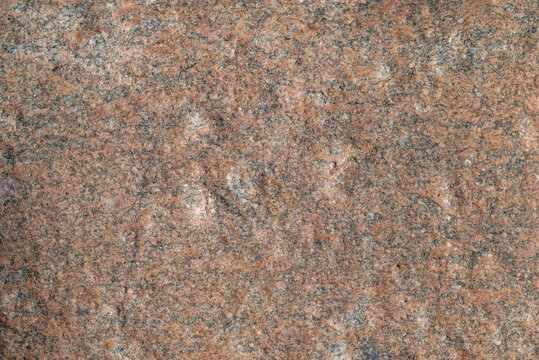 Stone texture. Detailed texture of natural pink granite stone surface close up.