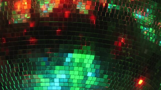 Vibrant light patterns dance across a shimmering disco ball, transitioning from cool hues to fiery reds and golden glows, igniting an electrifying nightlife celebration.
