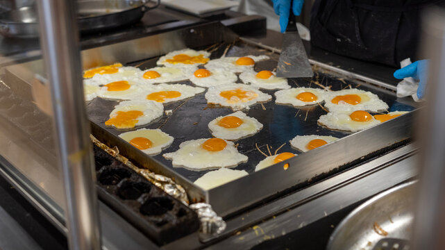 Cooking Multiple Fried Eggs on Large Commercial Griddle