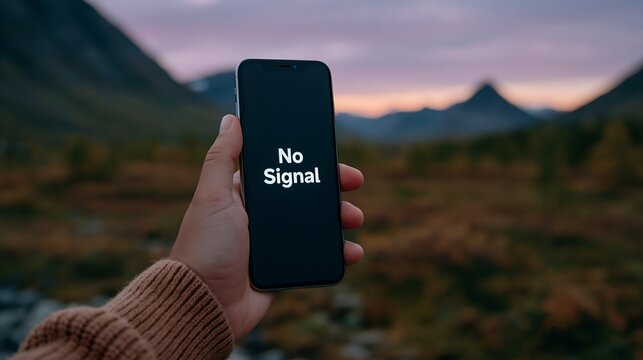 Hand holds phone showing 'No Signal' against mountain backdrop