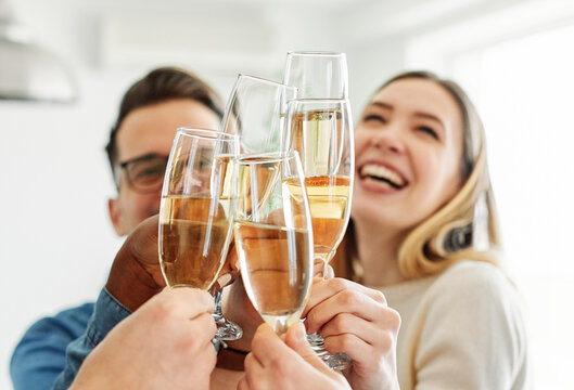 A portrait of young businesspeople or friends celebrating business success with a tost  in the office or young people having a party, teamwork and togetherness and having fun and friendship concept