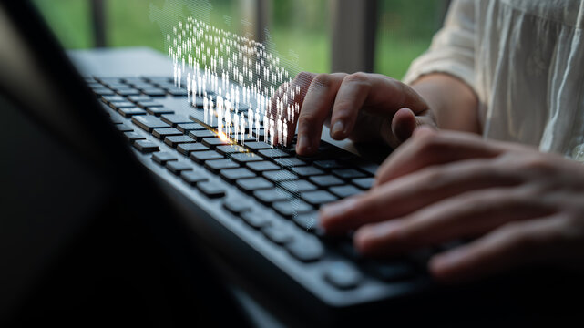 Person Typing on Keyboard with Digital Data Visualization Overlay in Modern Workspace Environment Quark.