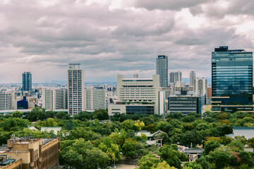 Fototapeta premium Viewing business district with contemporary architecture and layered cityscape in daylight, Osaka, Japan 