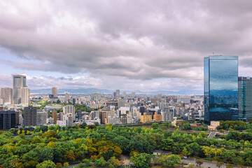 Obraz premium Viewing business district with contemporary architecture and layered cityscape in daylight, Osaka, Japan