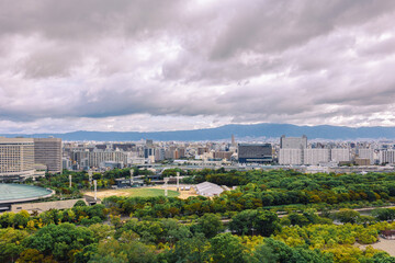 Fototapeta premium Viewing business district with contemporary architecture and layered cityscape in daylight, Osaka, Japan