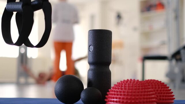 Foam roller, massage ball and balance dome on fitness mat in gym studio for workout and stretching.
