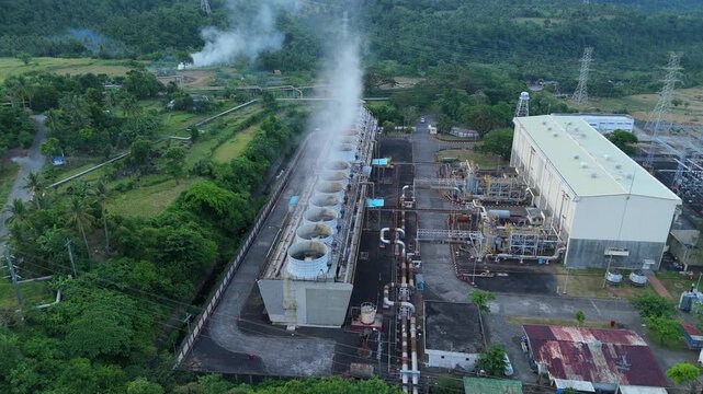 Geothermal cooling towers and steam emissions at Tiwi Geothermal Power Plant, Albay Philippines. Ideal for environmental and industrial concepts.