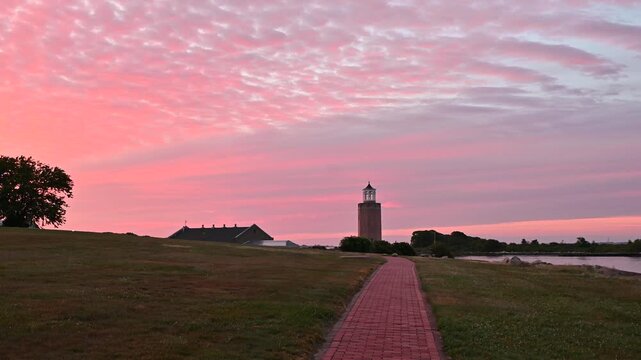 Groton, Connecticut, USA - Brick Walkway Leading To Avery Point Lighthouse At Sunrise