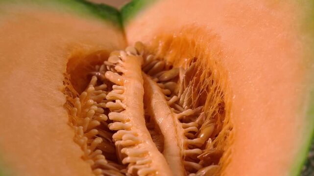 Sliced sweet cantaloupe melon revealing its inner seeds