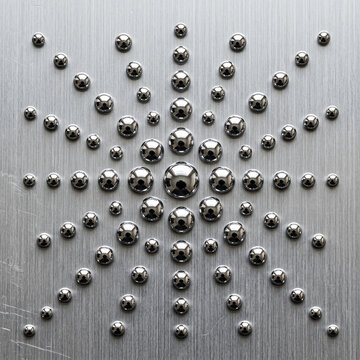 Metallic Starburst Pattern of Spheres on Brushed Metal Surface