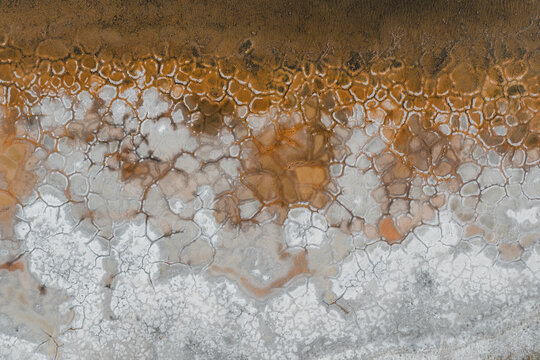 Aerial view of the cracked salt flats with intricate patterns and textured earth in La Ventana, Baja California Sur, Mexico.