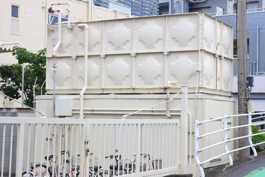 Large FRP panel-type water storage tank installed on a building property