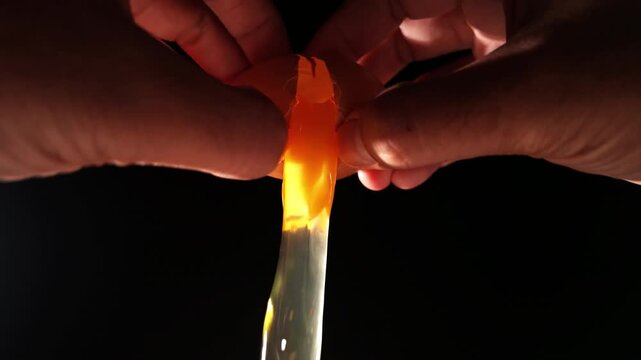 Cracking Egg over Flame Close Up with Fire and Dramatic Lighting