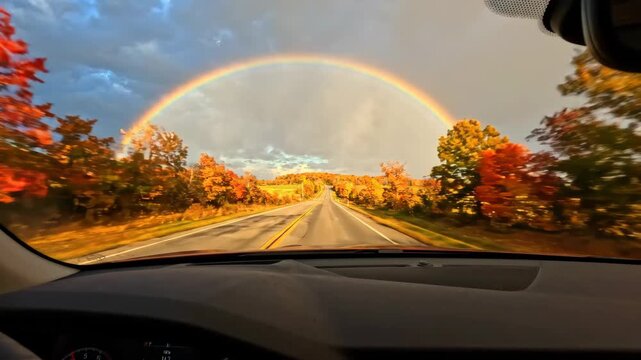 Rainbow Autumn Road Car Dashboard Sky Tree Colorful Travel Scenic Outdoor Nature Drive Under Vibrant Rainbow Arching Over Colorful Trees and Dramatic Sky Creating Inspiring Autumn Road Scene