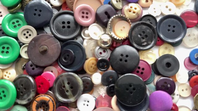 Close up background of buttons many different colours and shapes texture and a moving shot panning UK 4K