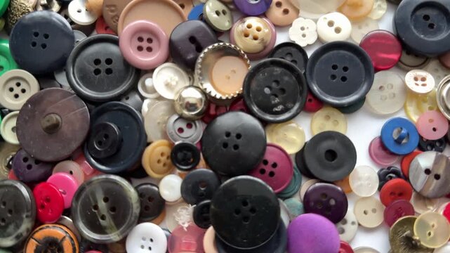 Close up background of buttons many different colours and shapes texture and a moving shot panning UK 4K