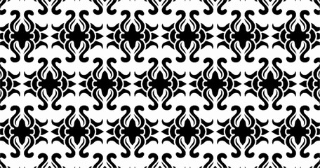 Obraz premium Abstract black and white seamless pattern with symmetrical ornamental motifs. Repeating vector design ideal for wallpaper, textiles, wrapping paper, and decorative surfaces.
