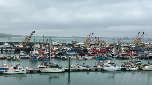Newlyn Cornish fishing village in England with boats in the harbour scenic area for vacation and holiday but once a port for the fish industry UK 4K