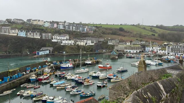 Newlyn Cornish fishing village in England with boats in the harbour scenic area for vacation and holiday but once a port for the fish industry UK 4K