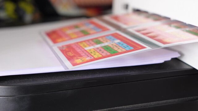 A printer that is currently working and printing a document; a printer used in offices, schools, or similar settings. Teaching materials, worksheets for students.