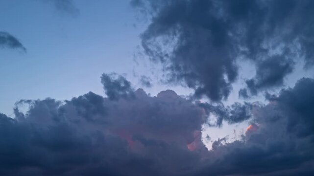 Sunset Sky timelapse. Moving clouds and sunset. Clouds float through the evening. Dusk twilight sky time lapse. Dramatic skies are moving. Cumulus and cirrus on storm. Sunrise cloudscape.