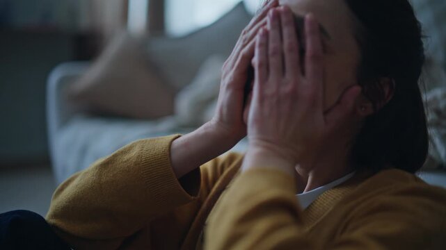 Exhausted woman thinking problems hiding face in palms closeup. Unhappy lady