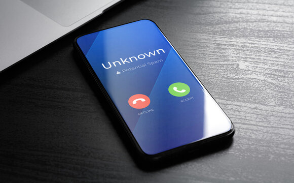 Spam call warning on smartphone screen. Unknown caller warning, suspected scam alert. Mobile fraud, robocall protection and cybersecurity concept. High quality photo