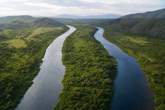 A forked river flowing in separate directions, two parallel waterways never meeting.