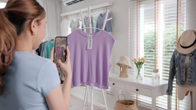 Young adult woman asia people take photo used shirt second hand sell. Go green happy home eco care reduce zero waste fabric issue donate buy sale online app side hustle reuse swap clothes store shop.