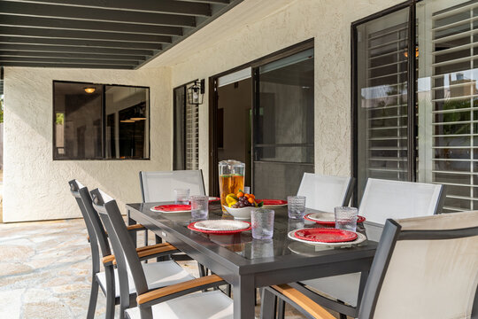 Outdoor dining table set for dining and dinner party, plates, glasses