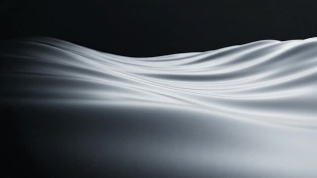 Abstract dark waves of smooth silk fabric in low light