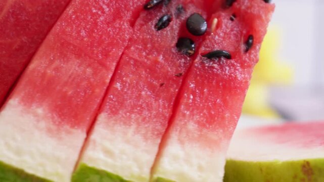 Close-up of a juicy slice of watermelon with black seeds, swirling. Fresh and sweet fruit, ideal for summer meals or desserts. Perfect for food blogs, cookbooks, or beverage advertisements.