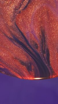 Vertical video. Defocused swirl. Bright curve ink. Orange purple shimmering acrylic emulsion mixing color stream in sphere abstract violet background.