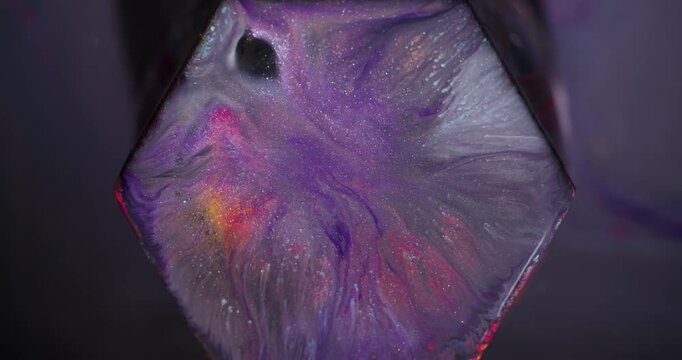Shiny splatter. Paint spill hexagon. Blur purple blue orange color geometric gem texture glitter particles on abstract background.