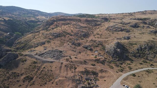 4K 10-bit drone shot flying forward and slowly descending over the ancient ruins of Hattusha, the lost Hittite capital in Turkey