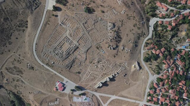 4K 10-bit top-down drone reveal shot ascending vertically to show the ancient Hittite ruins of Hattusha in Turkey