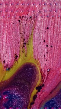 Vertical video. Ink spill. Electronic microchip. Defocused blue pink yellow color round glitter bubbles water texture processor on abstract art background.