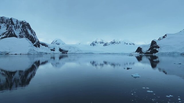 Aerial drone shot of Antarctica Scenery, Beautiful Mountains and Glacier Landscape on the Antarctic Peninsula in the Southern Ocean, Winter Seascape of Ocean Snow Ice in Cold Weather at Port Charcot