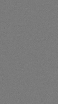 Vertical format vintage 16mm film grain with authentic scratches and noise for retro videos, seamless loop