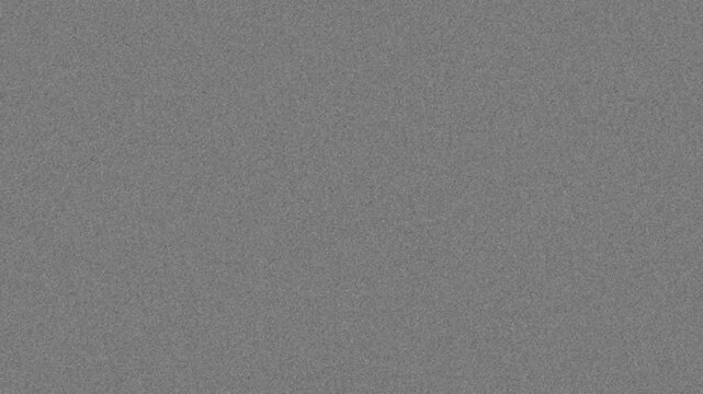 Vintage 8mm film grain texture overlay on black background seamless loop