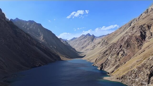 Static hyperlapse overlooking the stunning Laguna del Inca surrounded by the Andes Mountains in Portillo, Chile. Crystal blue waters, rugged peaks, and changing light conditions create a dramatic Sout