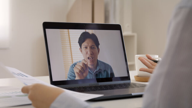 Bad boss video call work argue point face stress rude yelling anger hate speech at male coworker. Two asia people man woman fight on laptop meeting at office upset mad bossy worker. Career job issue.