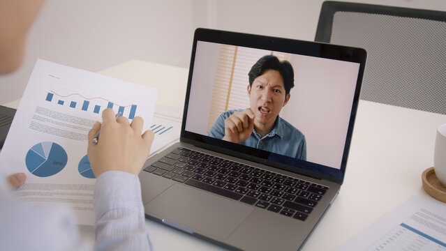 Bad boss video call work argue point face stress rude yelling anger hate speech at male coworker. Two asia people man woman fight on laptop meeting at office upset mad bossy worker. Career job issue.