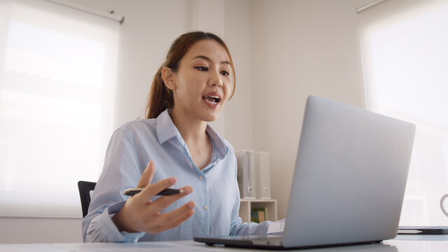 Bad Gen Z boss video call work argue point face stress yelling anger hate speech. Asia people woman fight on laptop videocall upset mad bossy. Online job issue mental health illness burnout at office.