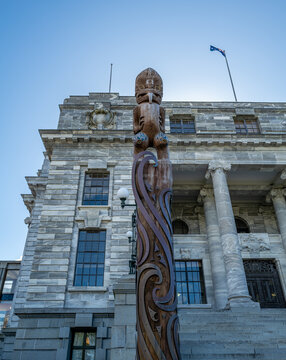 A Māori pou stands before New Zealand's Parliament House in Wellington, as ongoing debates over Māori rights and Treaty of Waitangi legislation continue to divide the nation ahead of the 2026 election